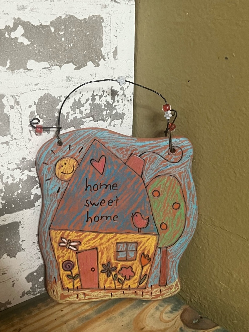 Home Sweet Home" decorative wall plaque featuring a whimsical house design